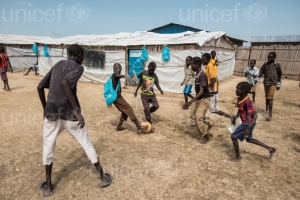 On 27 October 2015 in Malakal, children play during the school break in UNICEF supported primary school yard in Malakal Protection of Civilians site (PoC), Malakal, South Sudan. 470 children attend from grades 1 through 6. The school has five classrooms and seven teachers who teach English, Social Science, Christian Religious Education, and Mathematics. Due to the lack of space in the PoC, the same classrooms are used for CFS activities in the afternoon.