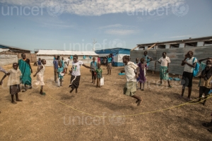 On 27 October 2015 in Malakal, children play during the school break in UNICEF supported primary school yard in Malakal Protection of Civilians site (PoC), Malakal, South Sudan. 470 children attend from grades 1 through 6. The school has five classrooms and seven teachers who teach English, Social Science, Christian Religious Education, and Mathematics. Due to the lack of space in the PoC, the same classrooms are used for CFS activities in the afternoon.
